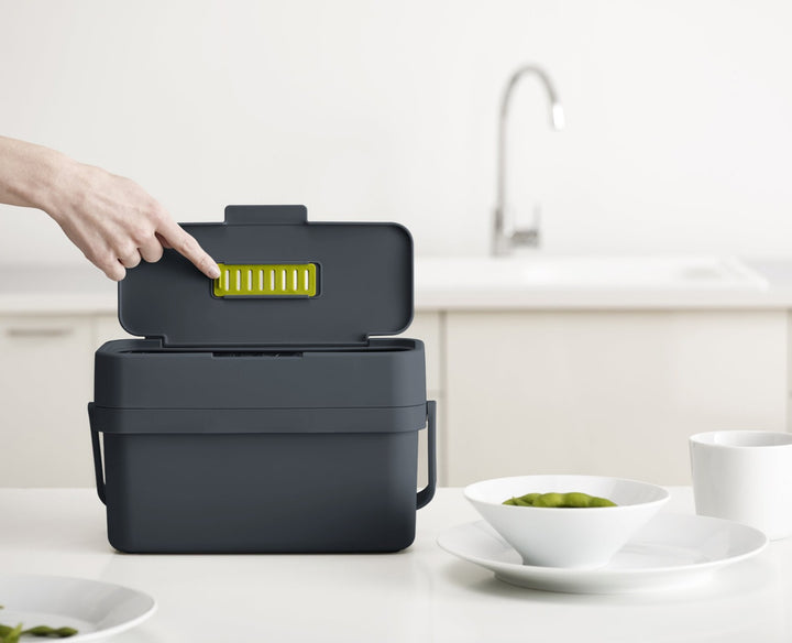 Grey food caddy with filter storage