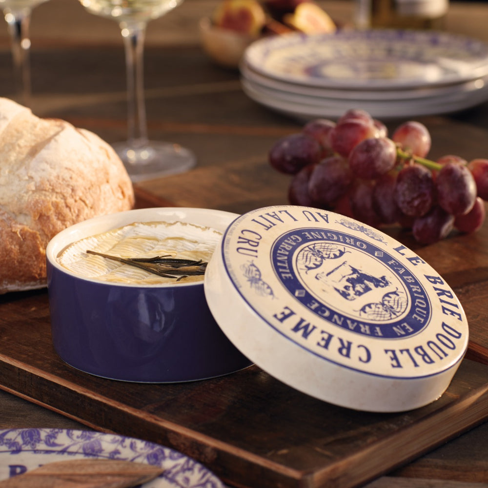 cheese baker with melted brie and grapes on tabletop