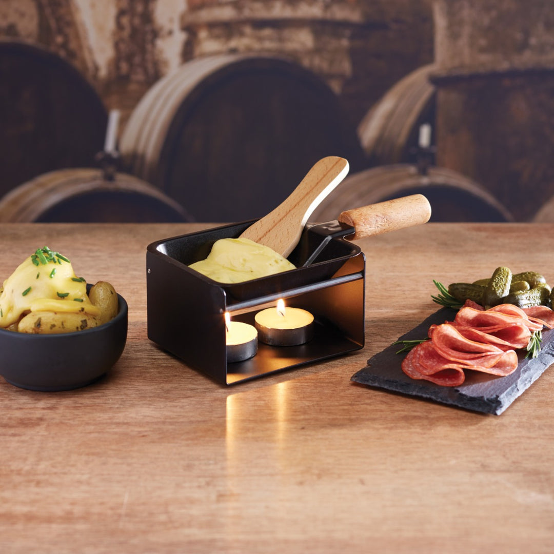 Cheese melting pan with wooden spatula