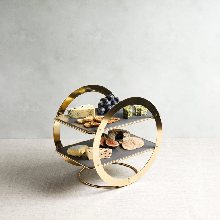 two tier brass serving stand with cheeses and fruits