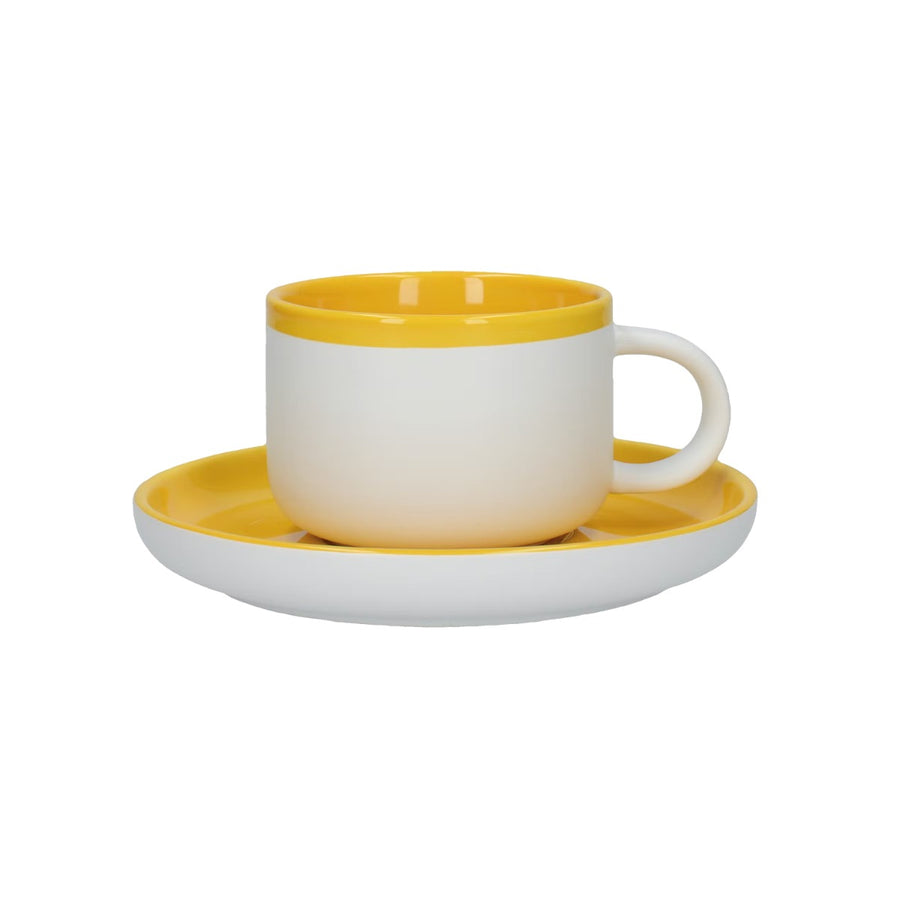 a tea cup and saucer set made from ceramic with a bright yellow and white design