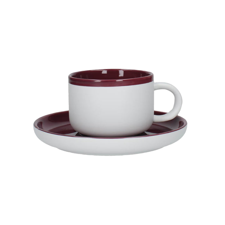 white teacup and saucer set with purple inner and top
