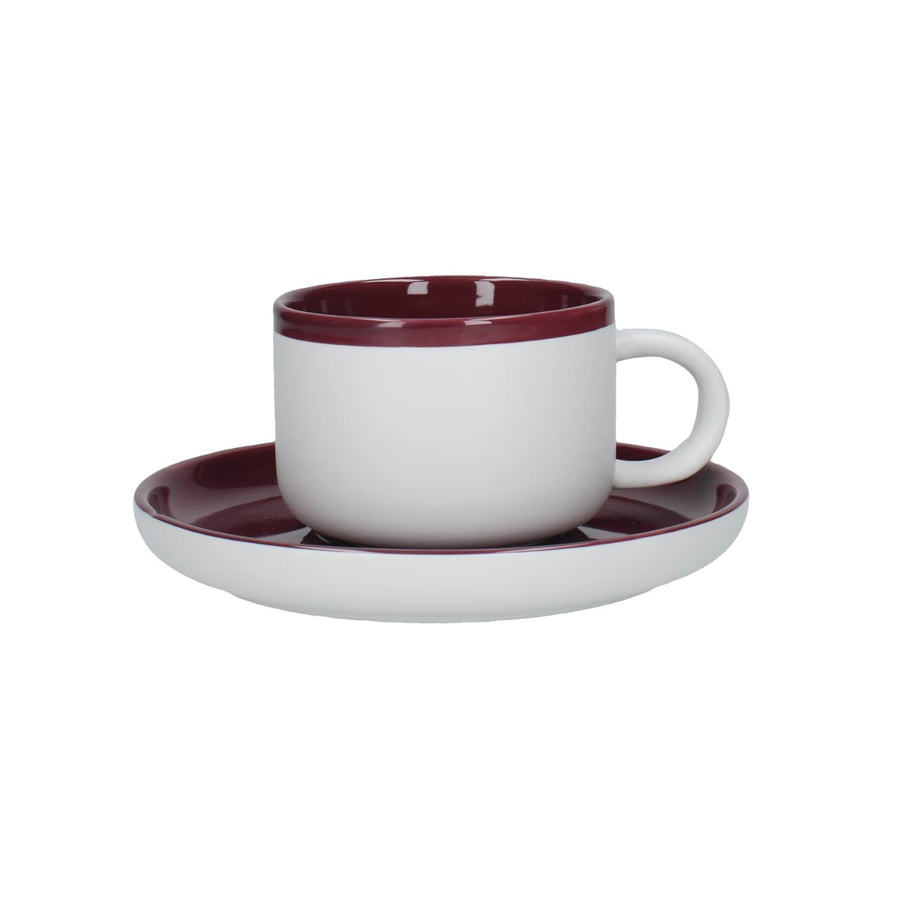 white teacup and saucer set with purple inner and top