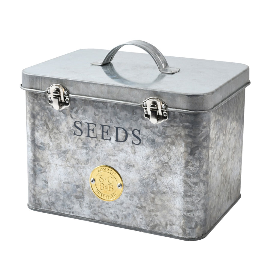 a silver galvanised steel seed storage tin, with metal clasps and carry handle and brass Sophie Conran seal