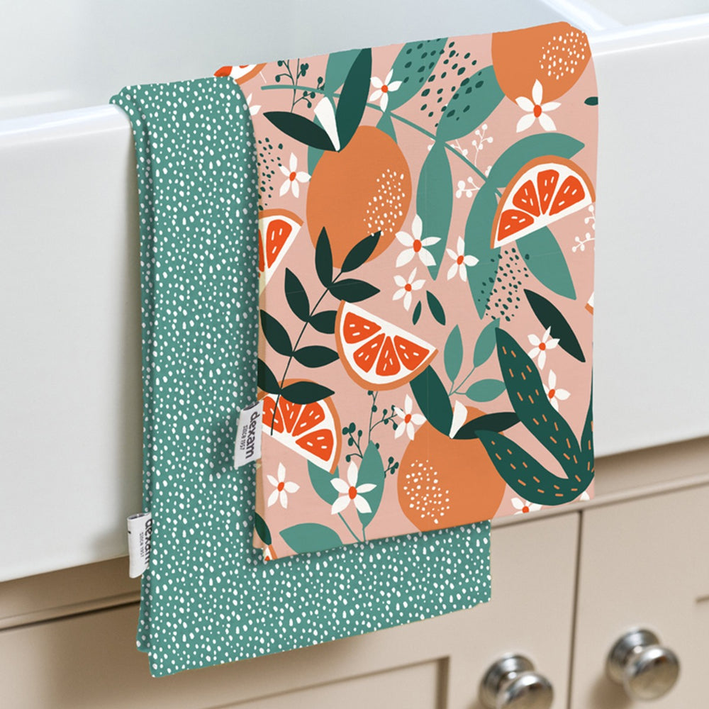  one with a pink fruit print and one with a teal polka dot print