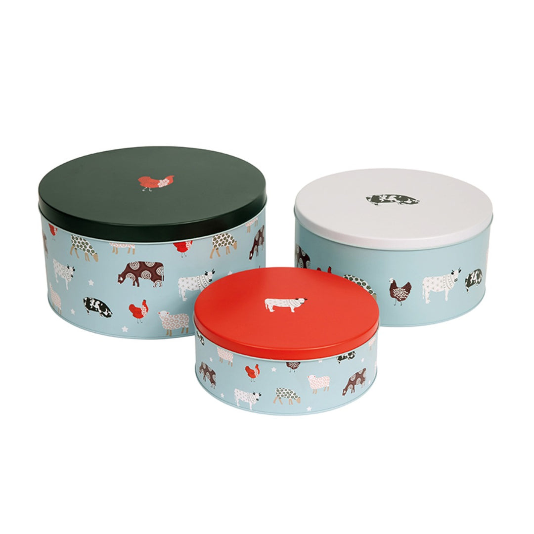 Different sized baked goods storage tins with contrasting lids
