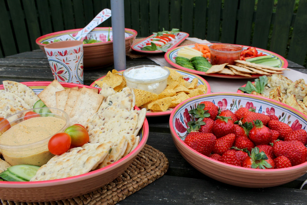 picnic food on a bench served in melamine dishes