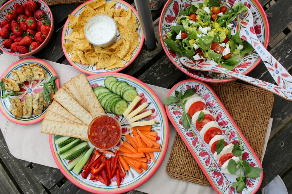 picnic food on red patterned melamine plates and bowls