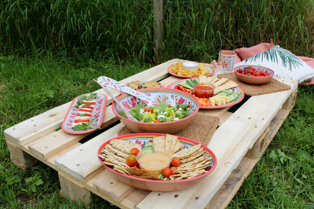 picnic food on a pallet in a field served in melamine dinnerware