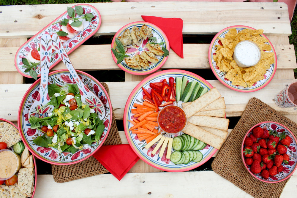 plastic plates and bowls on pallet for picnic with friends