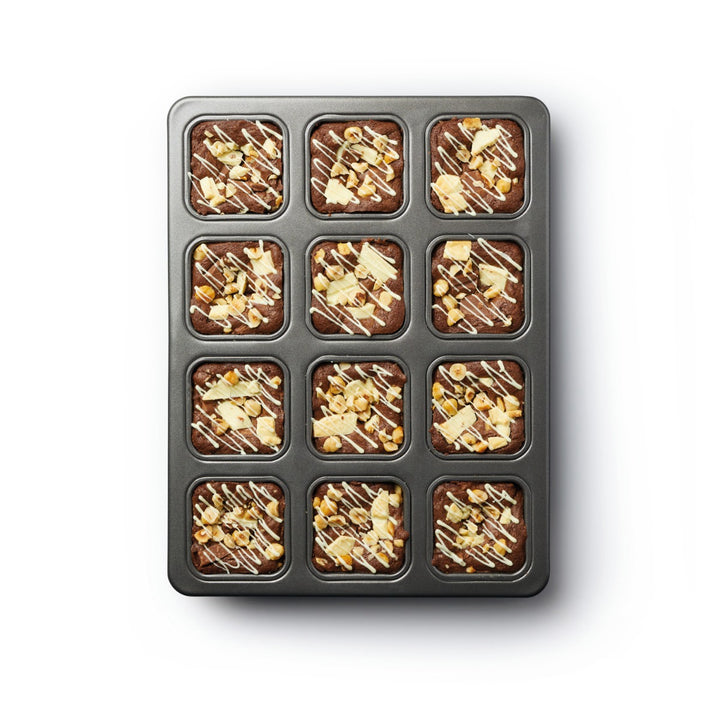 baked brownies with white chocolate topping in baking tin