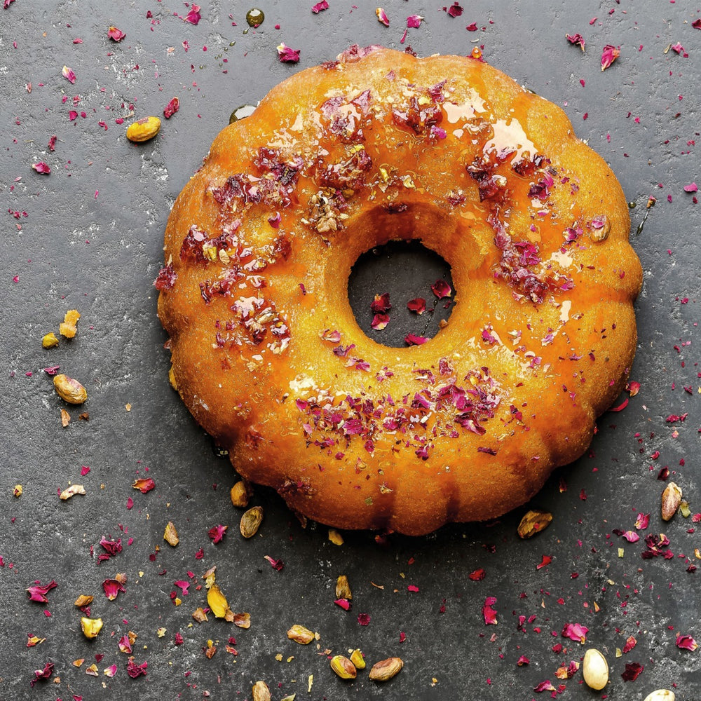 ring cake on slate surface with pink petals