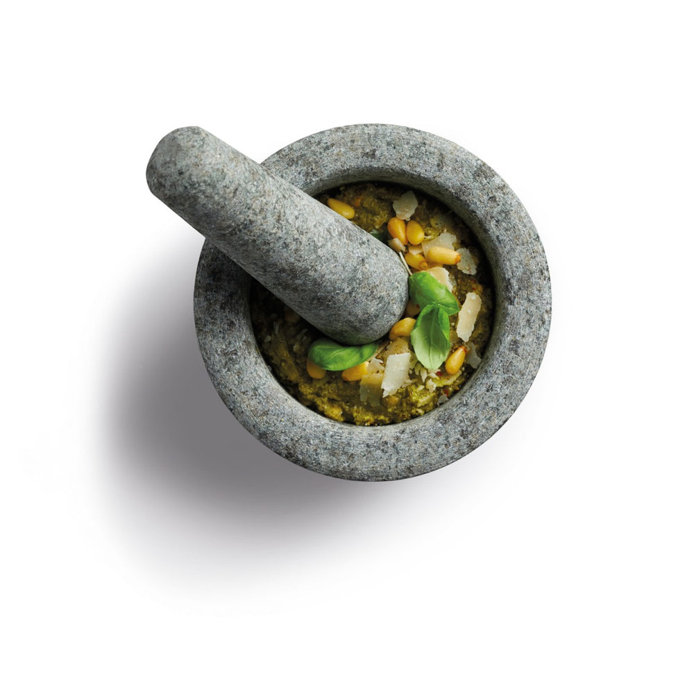 a pestle and mortar grinding up spices and herbs