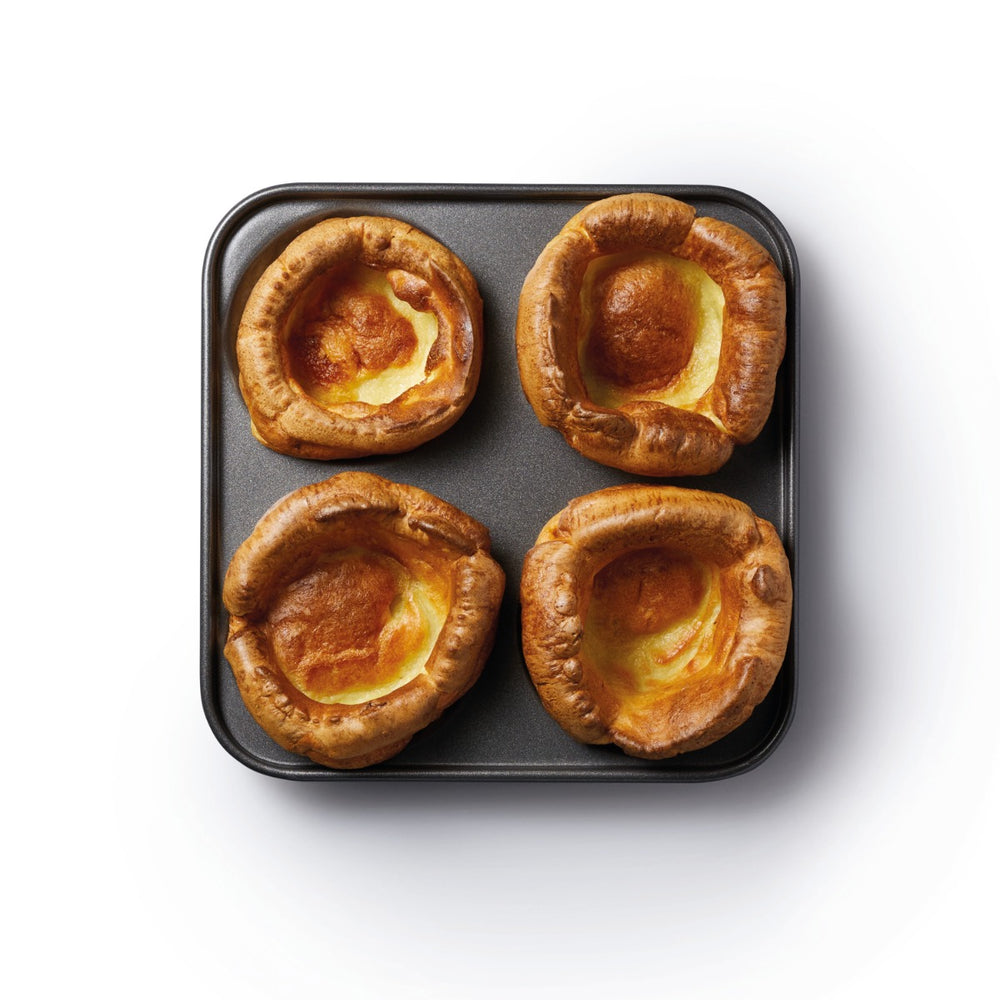 cooked yorkshire puddings in baking tin