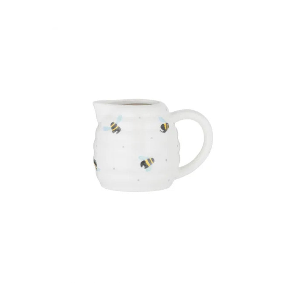 Tiny beehive shaped milk jug with flying bee design