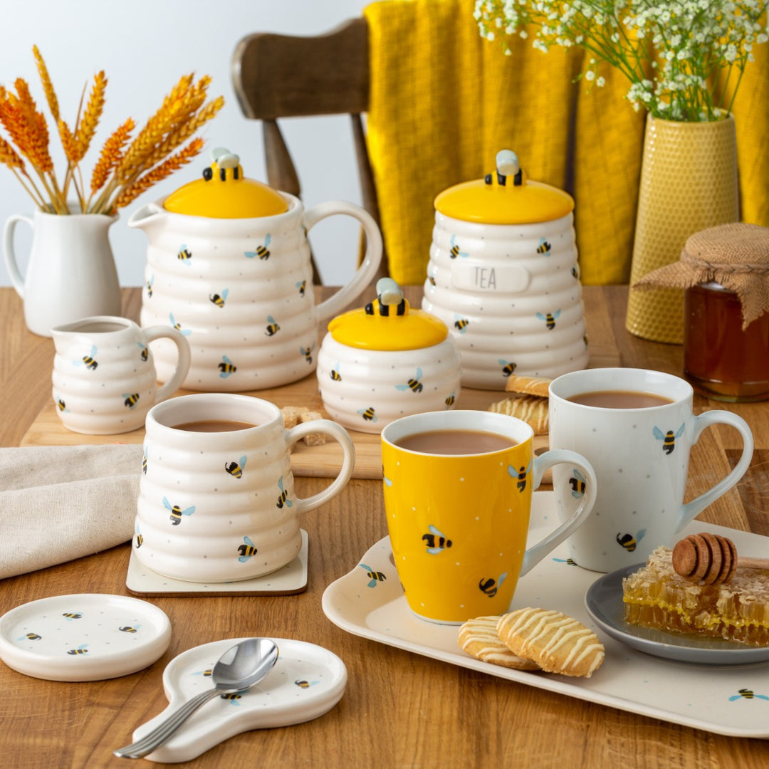 Tiny beehive shaped milk jug with flying bee design