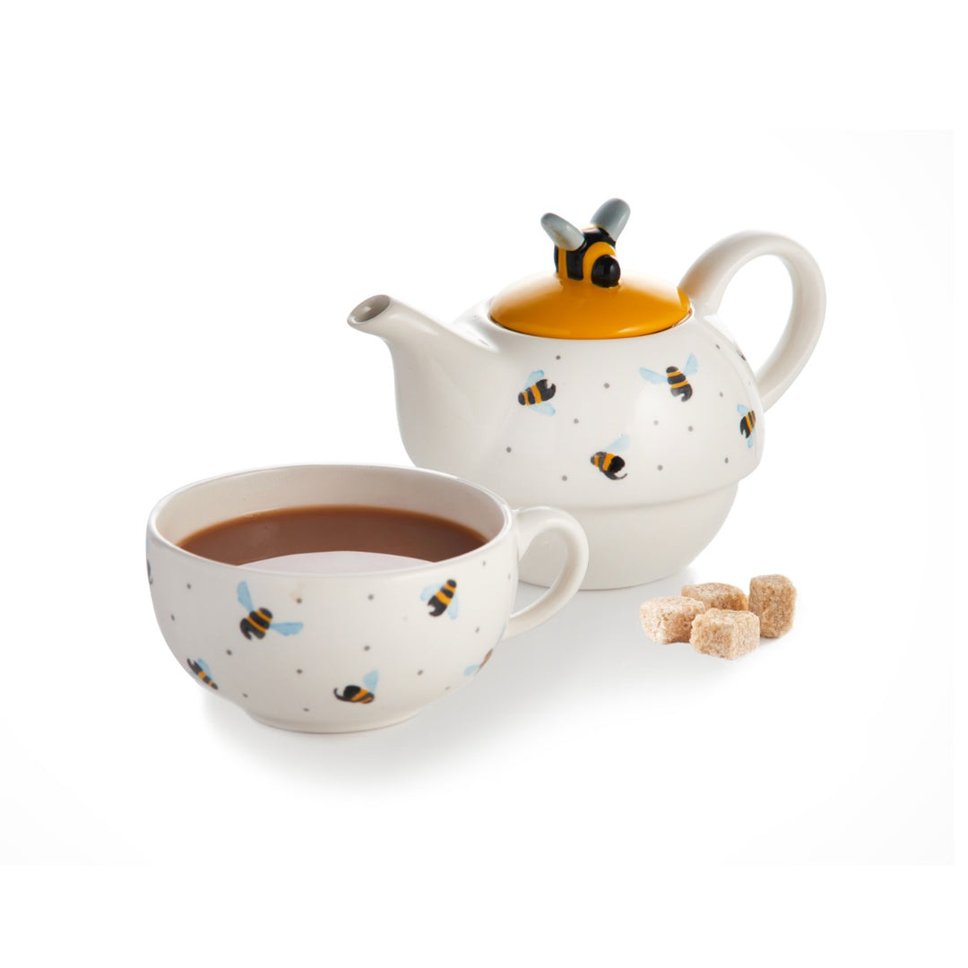 White teapot and cup set with blue winged flying bees and spotty print