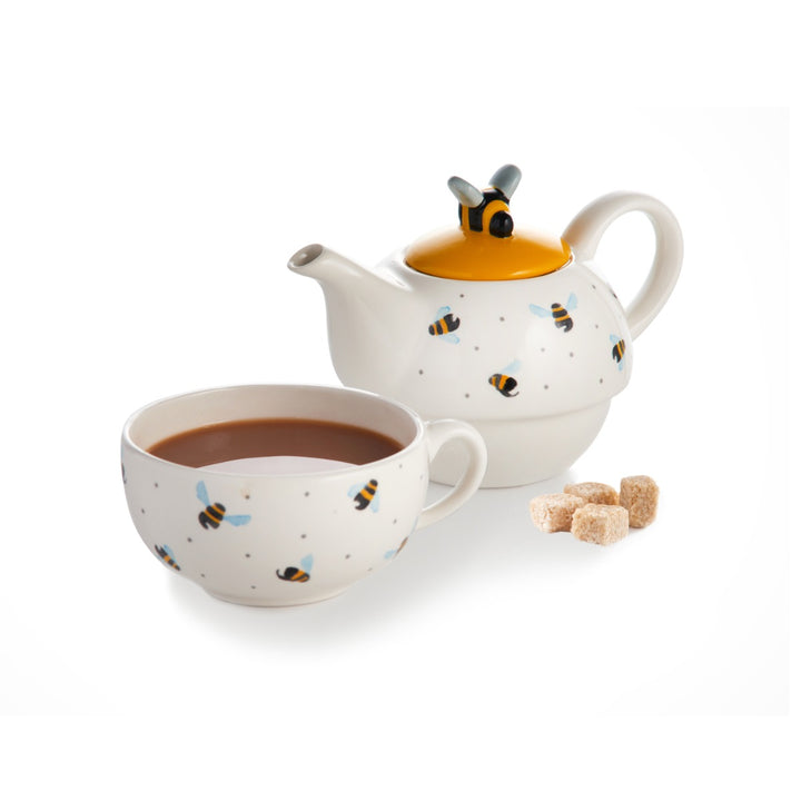 White teapot and cup set with blue winged flying bees and spotty print