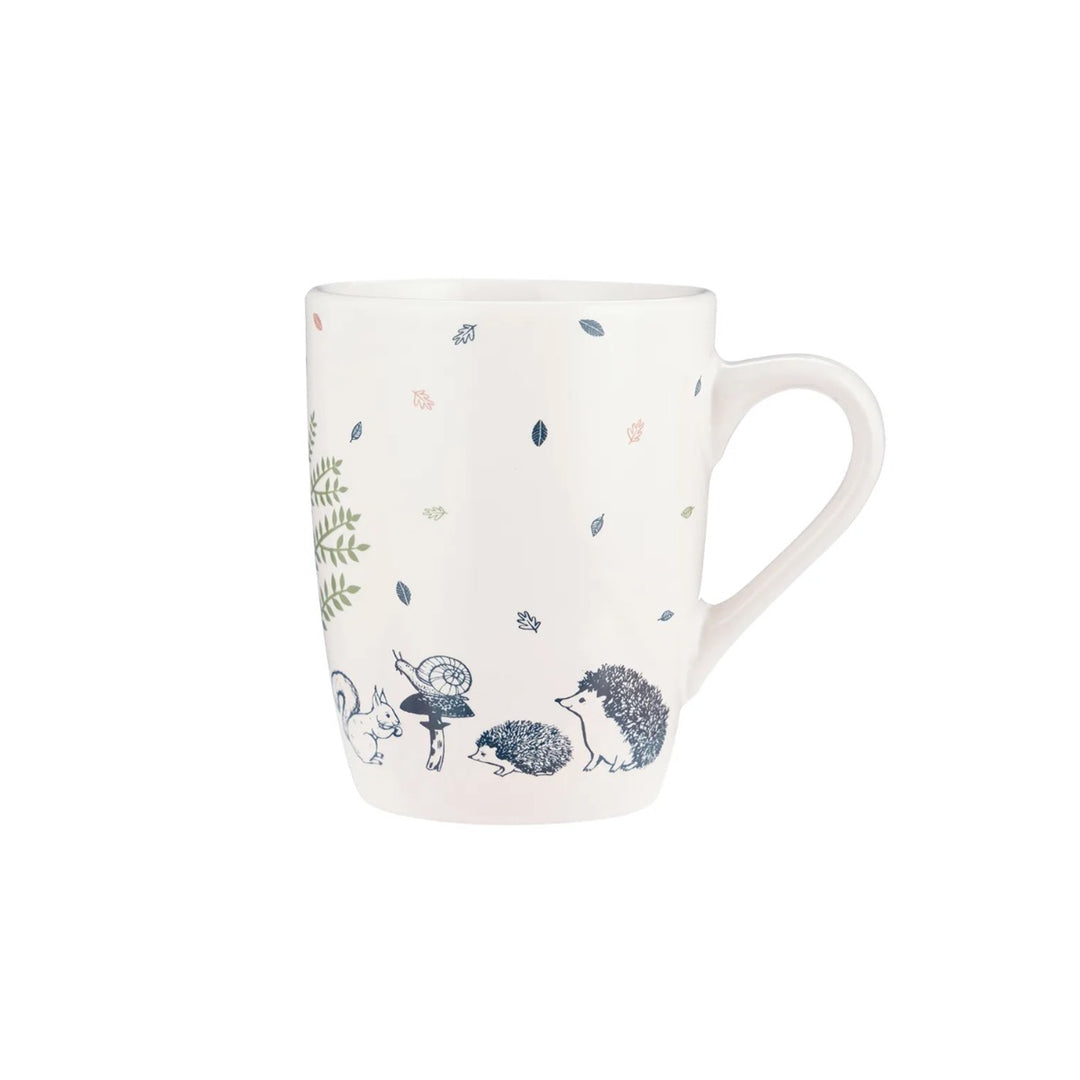 a cream stoneware mug with a navy blue woodland creatures design