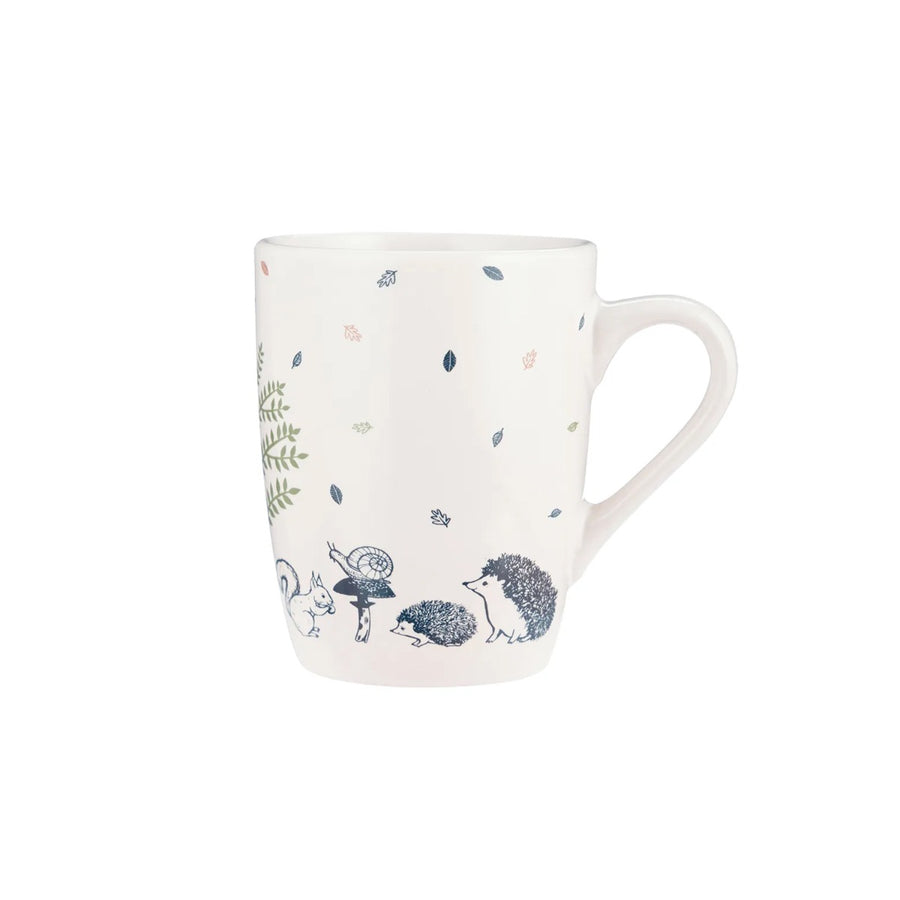 a cream stoneware mug with a navy blue woodland creatures design